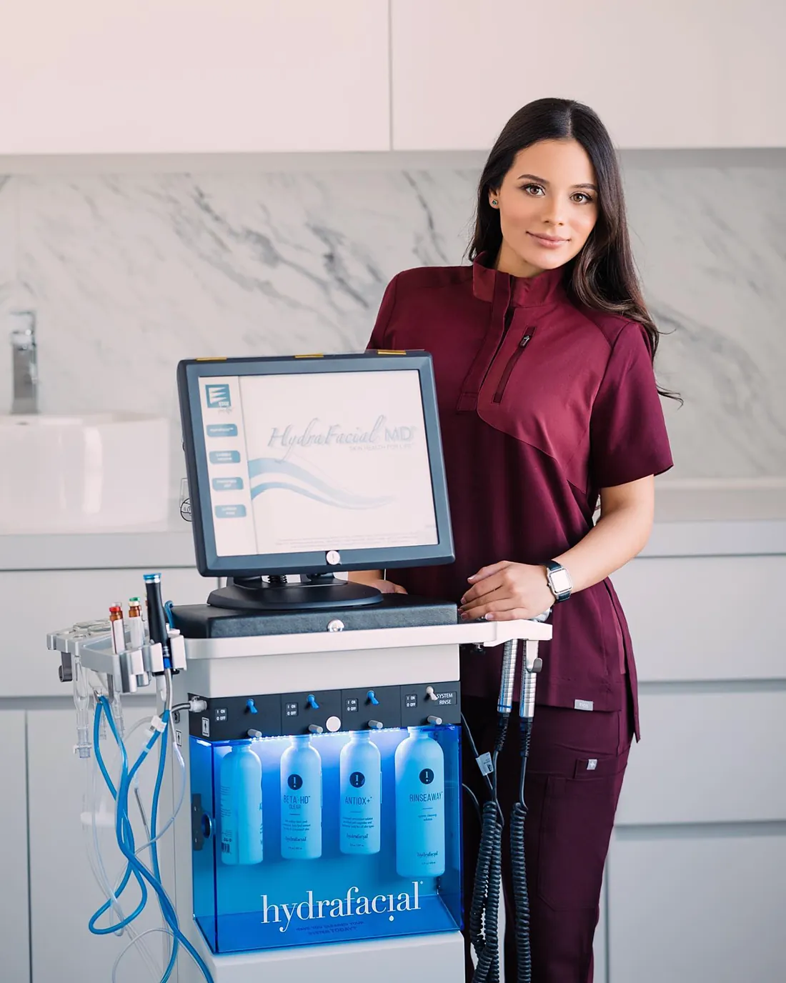 Dr. Vanessa Hernández next to the Hydrafacial device